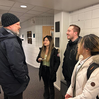 Photo of students and faculty talking.